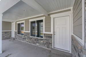 View of exterior entry with a porch