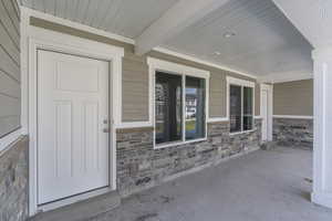 Property entrance with covered porch