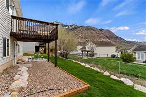 View of yard featuring a patio area and a deck with mountain view
