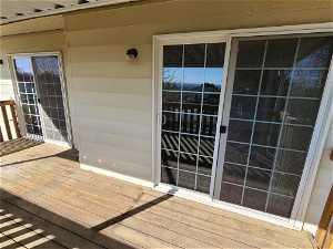 UPPER DECK WITH TWO SLIDING GLASS DOOR ENTRANCES FROM THE DINING AREA AND SITTING AREA!!