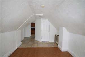 Bonus room featuring light hardwood / wood-style flooring and lofted ceiling
