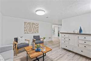 Spacious family room with light hardwood / wood-style floors