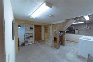 Basement featuring a textured ceiling and Washer/Dryer