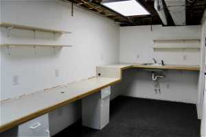 Extra large storage or craft room with electrical, plumbed sink, and counters