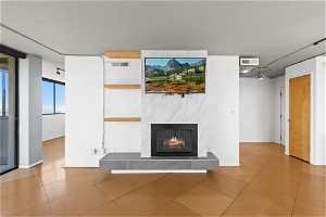 Unfurnished living room with light tile floors and a fireplace