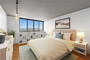 Virtual Staging - Bedroom with a wall of windows, light tile floors, and track lighting