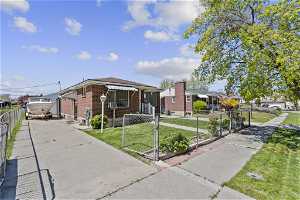 Bungalow-style house featuring a front lawn, long driveway for extra off street parking.