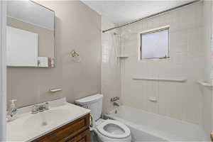 Full bathroom with vanity, toilet, and tiled shower / bath