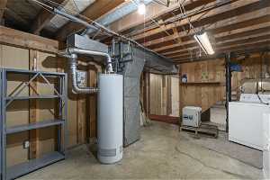 Basement featuring washer and clothes dryer and gas water heater. Storage space