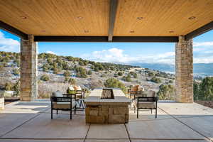 View of patio with a fire pit and a mountain view