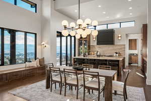 Dining space with dark wood-style floors, a mountain view, recessed lighting, and a high ceiling