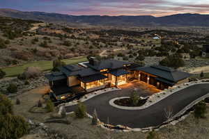 Aerial view of property and surrounding area with a mountainous background