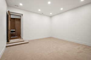 Unfurnished room featuring recessed lighting and light colored carpet