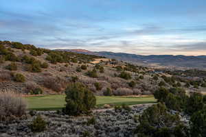 View of mountain backdrop with a golf course