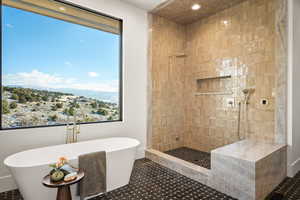 Bathroom featuring a freestanding bath, a walk in shower, and recessed lighting