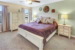 Master Bedroom featuring light colored carpet and ceiling fan