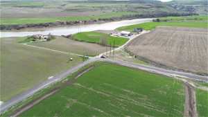 Birds eye view of property featuring a water view and a rural view