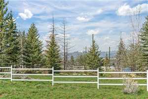 View of gate featuring a mountain view and a yard