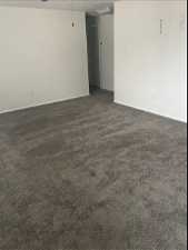 Unfurnished room with dark carpet