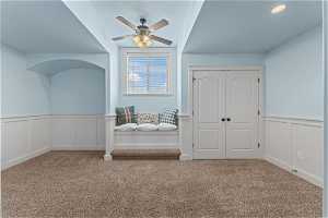 Additional living space featuring light carpet and ceiling fan