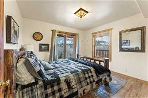 Bedroom featuring light hardwood / wood-style flooring and access to outside