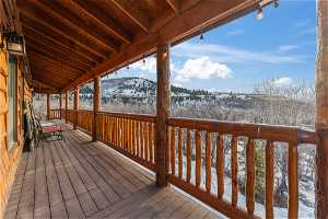 Snow covered deck with a mountain view