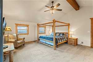 Carpeted bedroom featuring vaulted ceiling with beams and ceiling fan