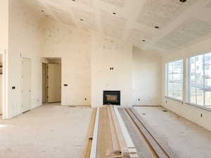 Unfurnished living room with a high ceiling