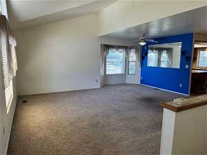 Unfurnished room featuring carpet floors and ceiling fan