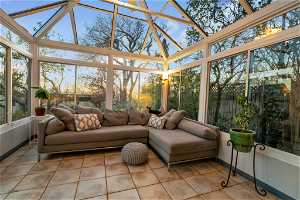 Sunroom / solarium with a healthy amount of sunlight and vaulted ceiling