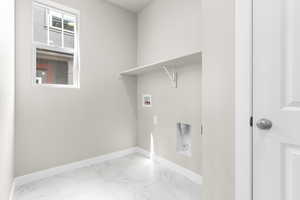 Laundry room with hookup for a washing machine and tile floors