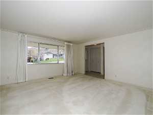 Carpeted empty room with crown molding