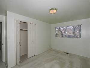 Unfurnished bedroom featuring light colored carpet and a closet