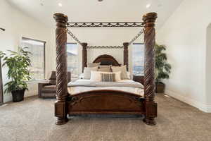 Carpeted bedroom featuring lofted ceiling