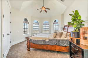 Carpeted bedroom featuring a closet, lofted ceiling, and ceiling fan