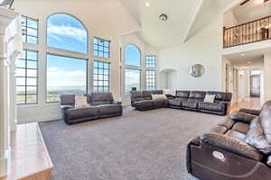 Living room featuring high vaulted ceiling and tile flooring