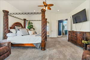 Bedroom with lofted ceiling, carpet floors, and ceiling fan