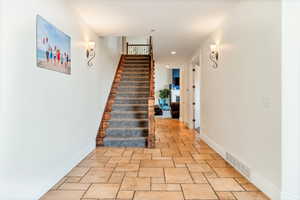 Stairs with light tile flooring