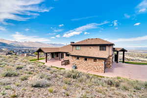 Rear view of property featuring a patio area and a mountain view