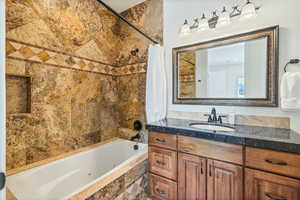 Bathroom with shower / tub combo and vanity