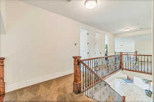 Hallway featuring tile floors