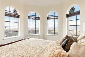 Bedroom with multiple windows and a water view