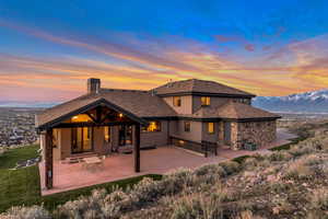 Back house at dusk featuring a patio area and a mountain view