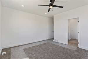 Unfurnished room featuring ceiling fan and carpet floors