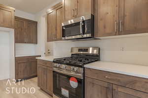 Kitchen featuring light hardwood / wood-style floors and appliances with stainless steel finishes