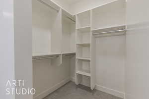 Spacious closet featuring carpet flooring