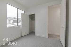 Unfurnished bedroom with a closet and light colored carpet