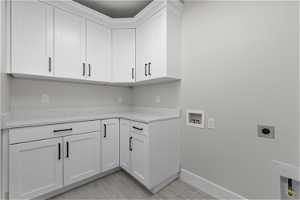 Laundry room featuring cabinets, hookup for an electric dryer, and hookup for a washing machine