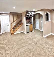 Interior space featuring sink and carpet flooring