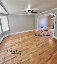 Unfurnished room with light hardwood / wood-style flooring, ceiling fan, a textured ceiling, and ornamental molding